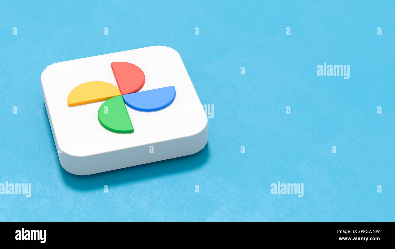 Google Photos App Icon on Blue Background with Copy Space Stock Photo