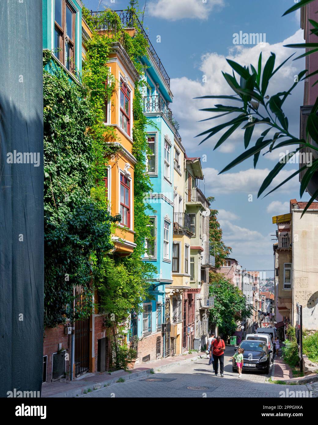 Traditional colorful old houses in Balat district, local pedestrians in a summer, Istanbul, Turkey Stock Photo