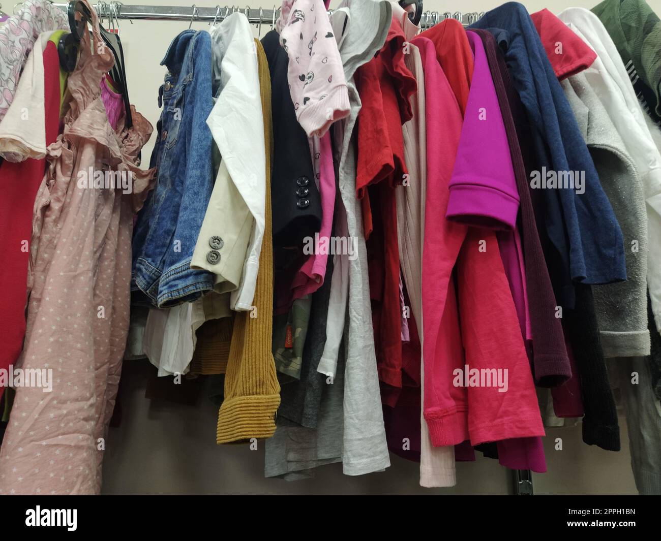https://c8.alamy.com/comp/2PPH1BN/clothes-hung-on-hangers-assortment-of-second-hand-store-childrens-and-womens-shirts-blouses-sweaters-hanging-on-a-rack-ready-for-sale-to-customers-saving-money-belgrade-serbia-22-april-2022-2PPH1BN.jpg
