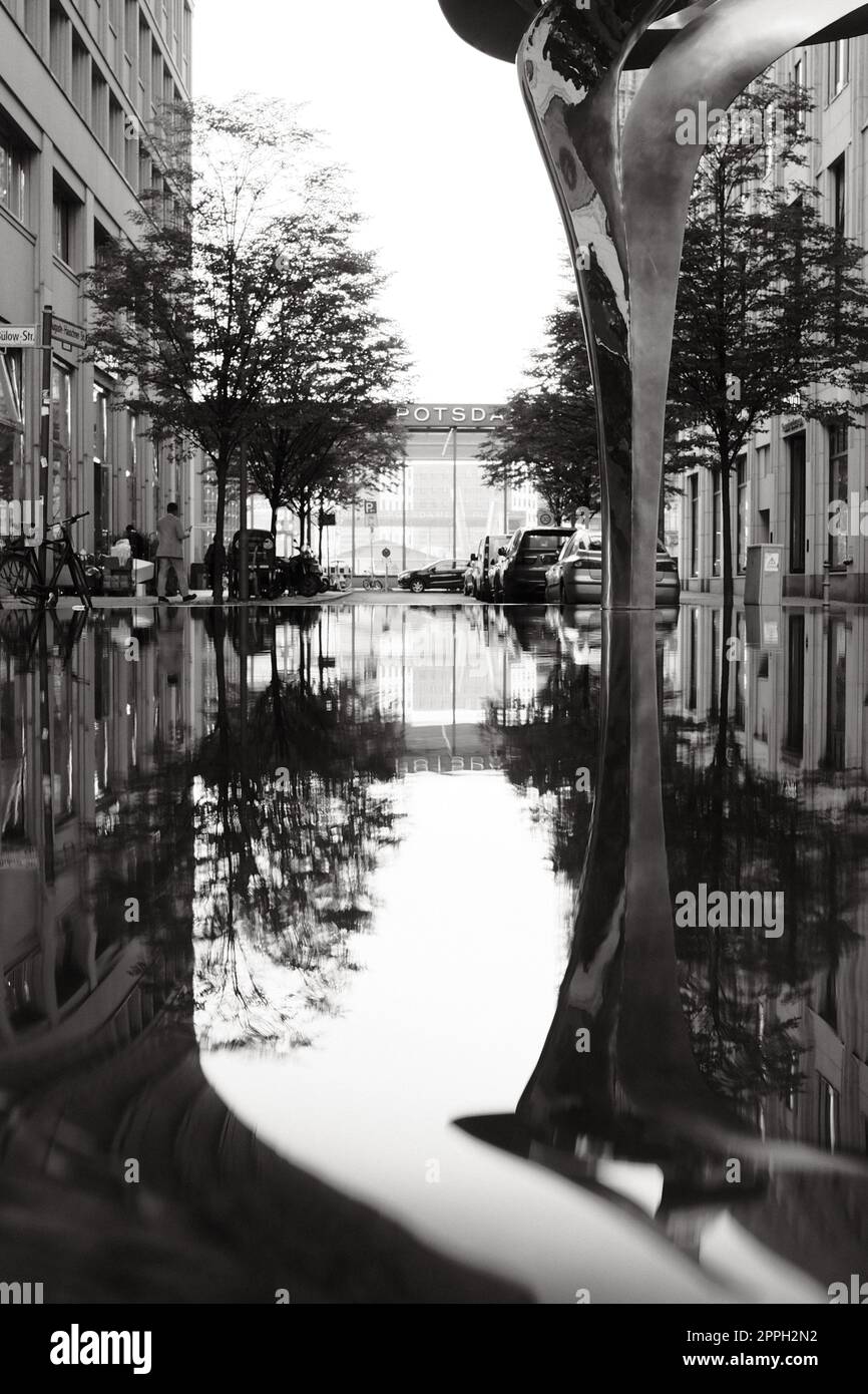 Vertical shot of the reflection of a sculpture in the water near Potsdamer Platz Stock Photo