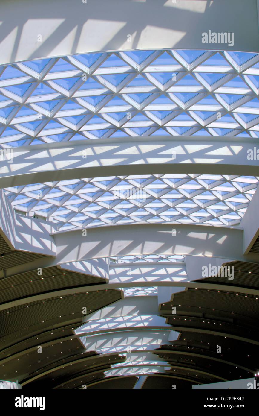 Large, modern design glass skylight at an airport. The beams form triangular patterns. Stock Photo