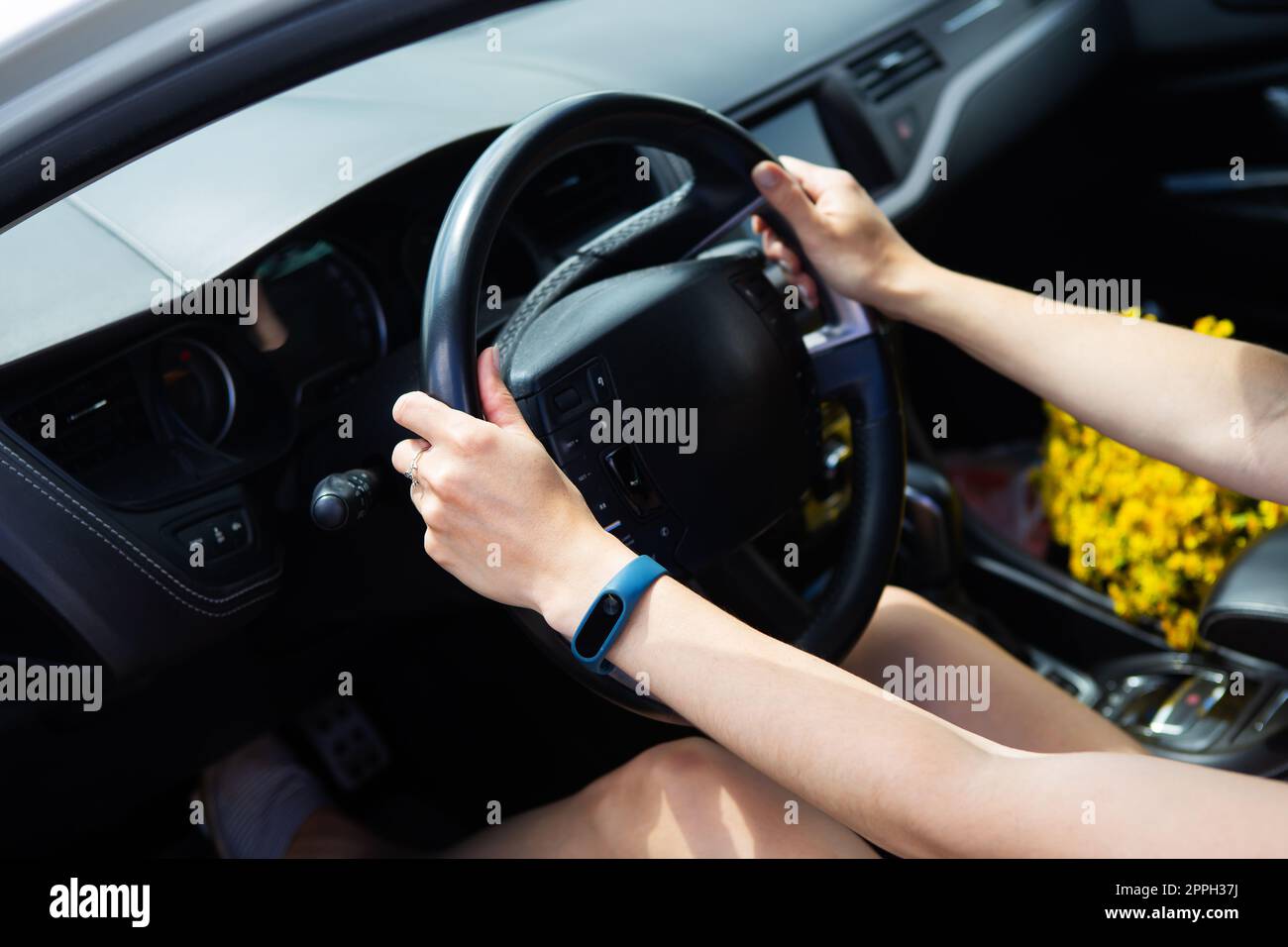 Young girl driving a car, handing over the right to drive a car. Stock Photo