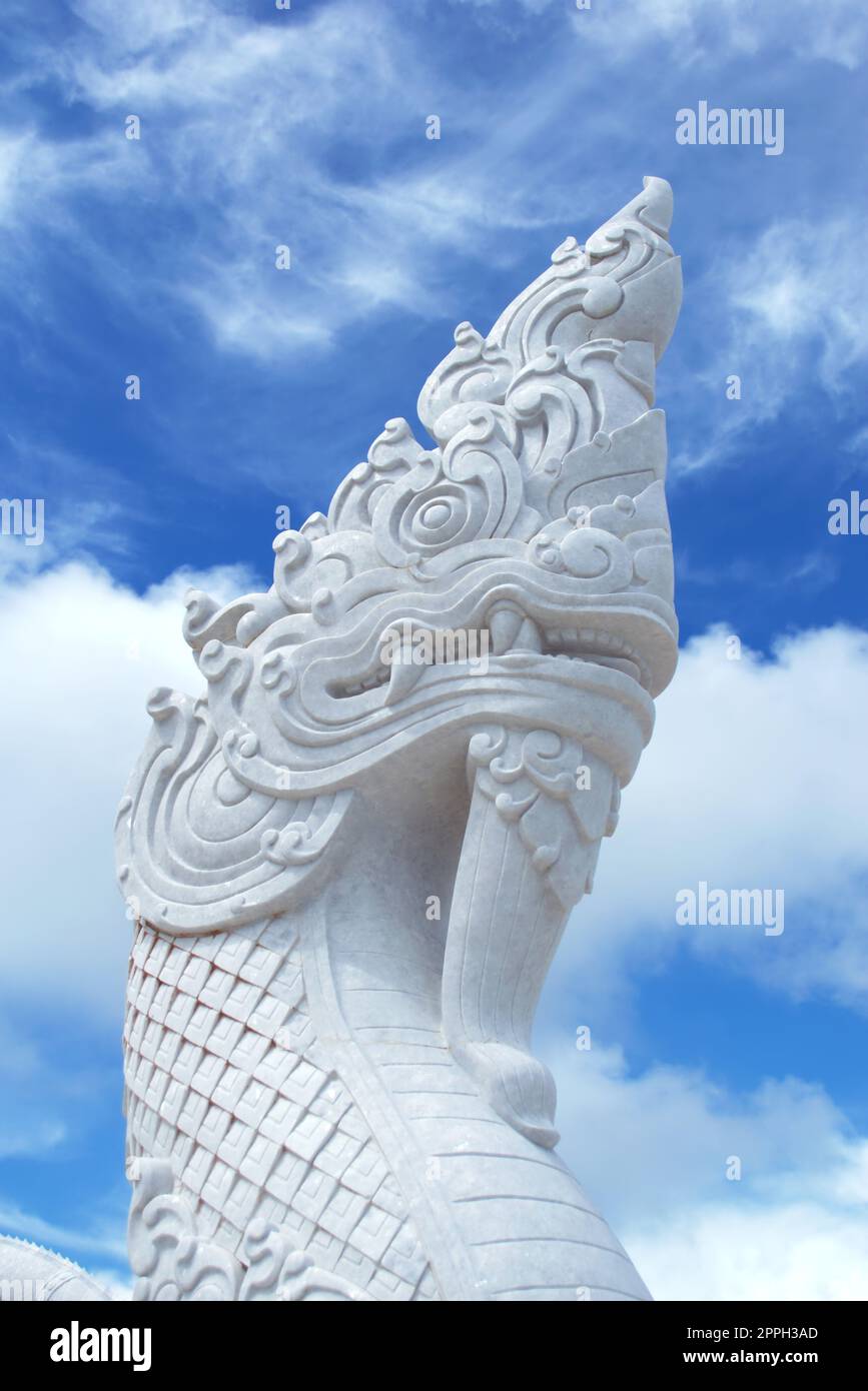 White marble statue of a buddhist Naga serpent in Thailand. Close up detail. Stock Photo