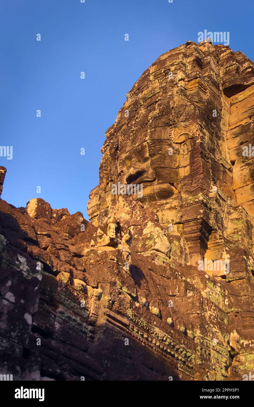 Stone face tower at Bayon temple, located in Angkor, Cambodia, the ancient capital city of the Khmer empire. View from the western inner courtyard. Stock Photo