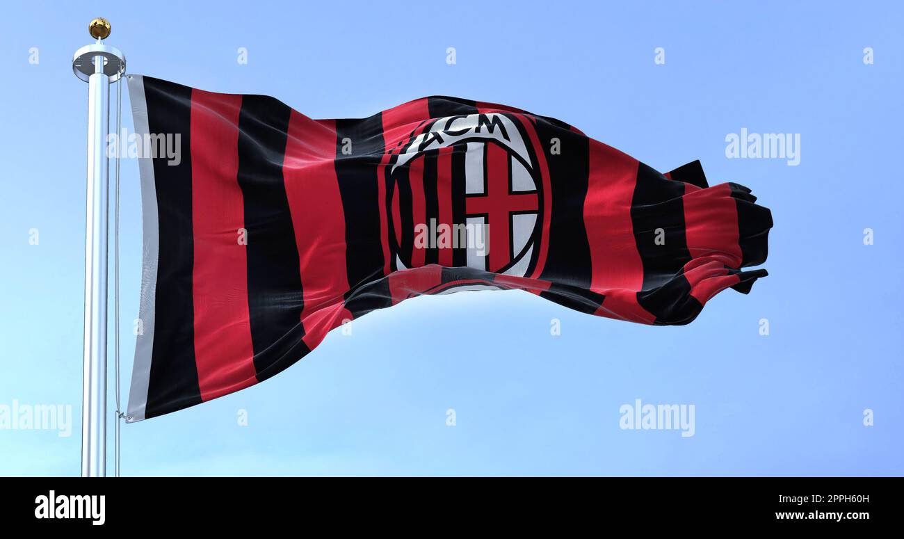 Milan, Italy, July 2022 The flag of A.C. Milan waving in the wind on a clear day. Milan is a