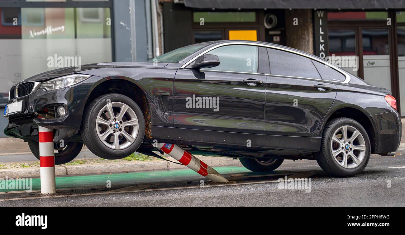 In the early hours of the morning, a passenger car hit the bollards of a bicycle path in the traffic-calmed HermannstraÃŸe (speed 30 km/h) in Berlin and suffered considerable damage to the underbody and engine compartment. The driver fled and left the veh Stock Photo