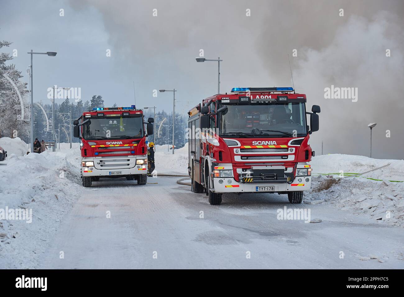 Fire trucks for emergency response at a burning building in Finland Stock Photo