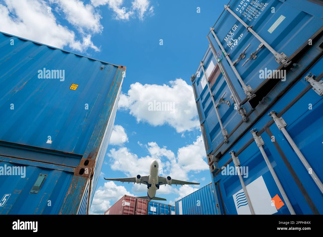 Airplane flying above logistic container. Air logistics. Cargo and