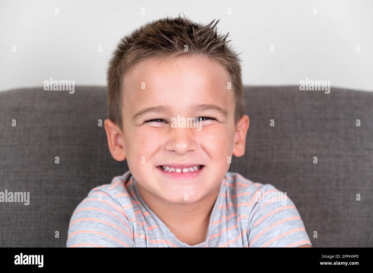 Portrait of a Funny little boy smiling and laughing looking at camera