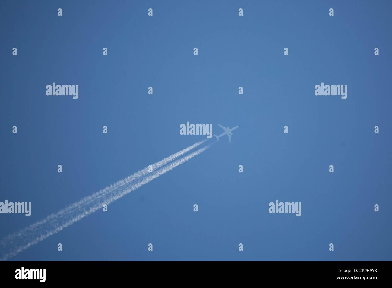 White Airplane in the Sky Stock Photo - Alamy