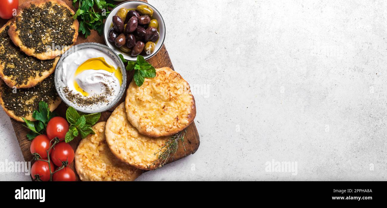 Arabic breakfast, labneh yogurt, manakeesh or pita bread with cheese