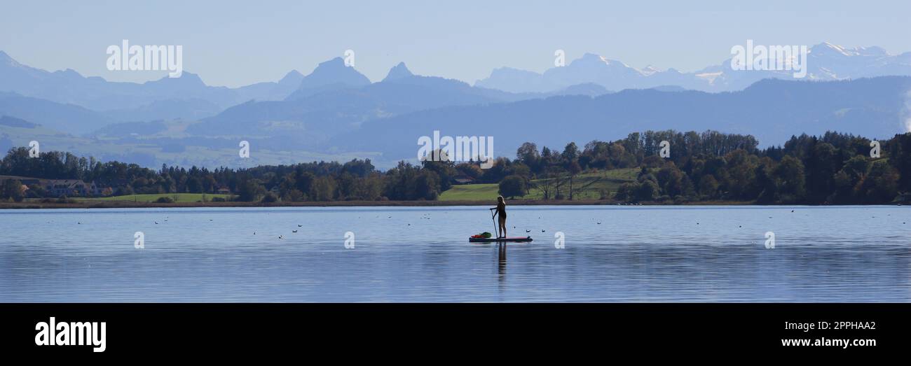 Stand up paddling on Lake Pfaeffikon. Stock Photo