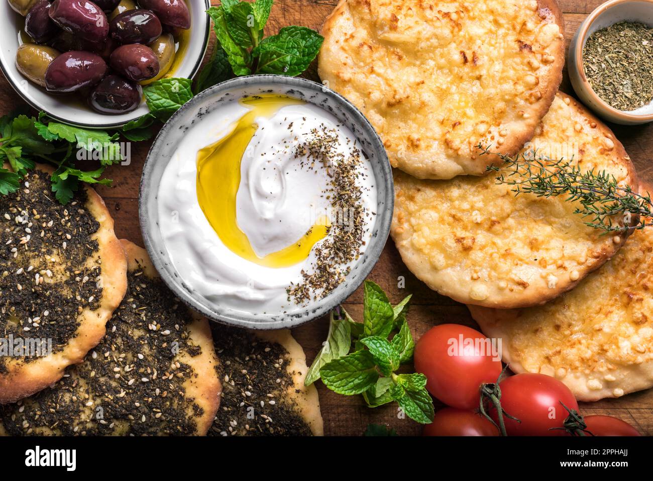 Arabic breakfast, labneh yogurt, manakeesh or pita bread with cheese