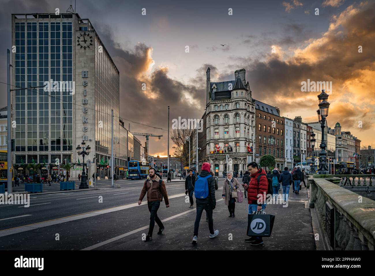 Early morning, sunrise, on busy OConnell Bridge with Luas and bus, Dublin, Ireland Stock Photo