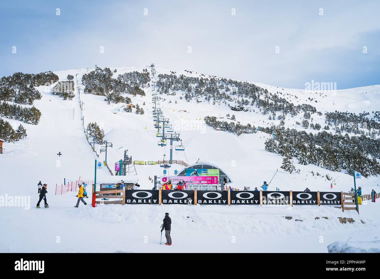 Group of people, skiers and snowboarders taking on ski lift in Pyrenees, Andorra Stock Photo