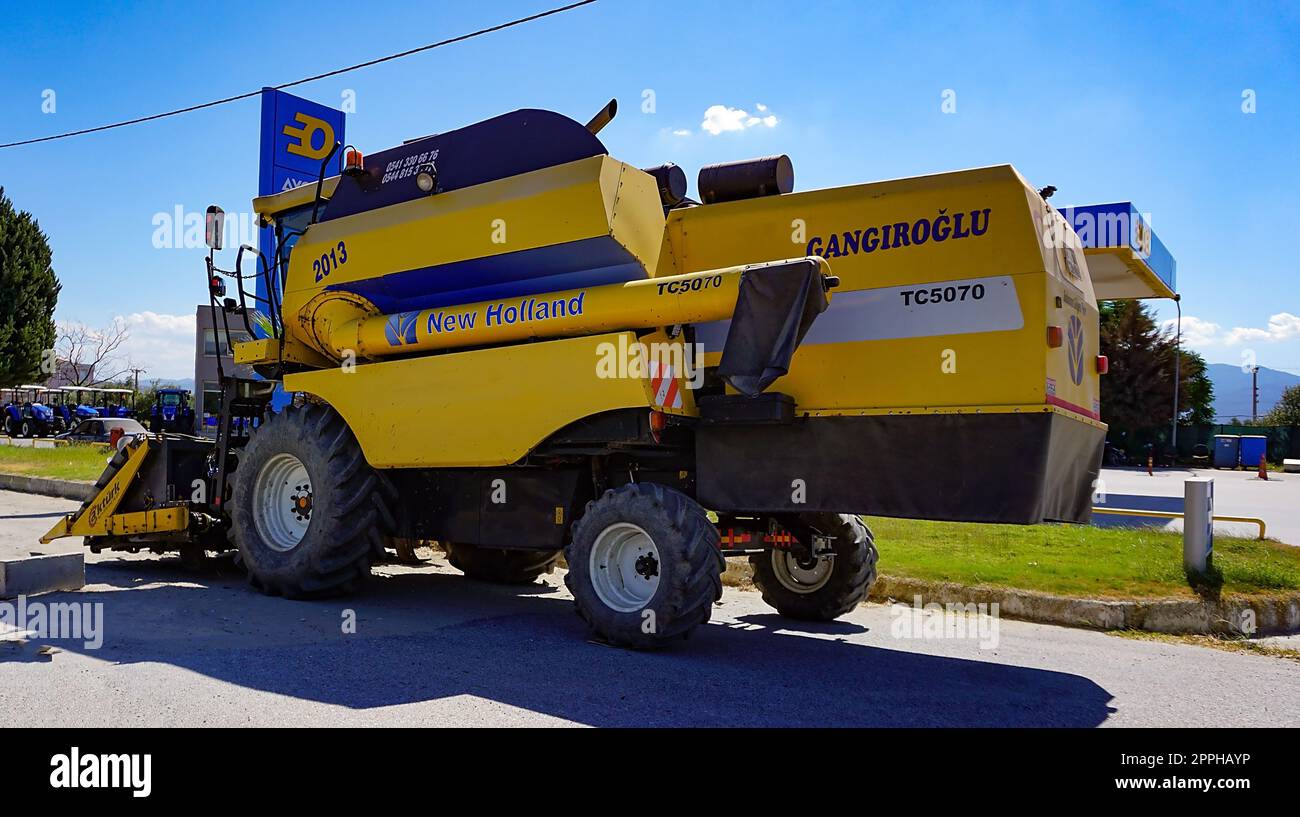 Araclar, Turkey - September 16, 2022: New Holland Agriculture logo in the dealership store against a blue sky at Araclar, Turkey Stock Photo