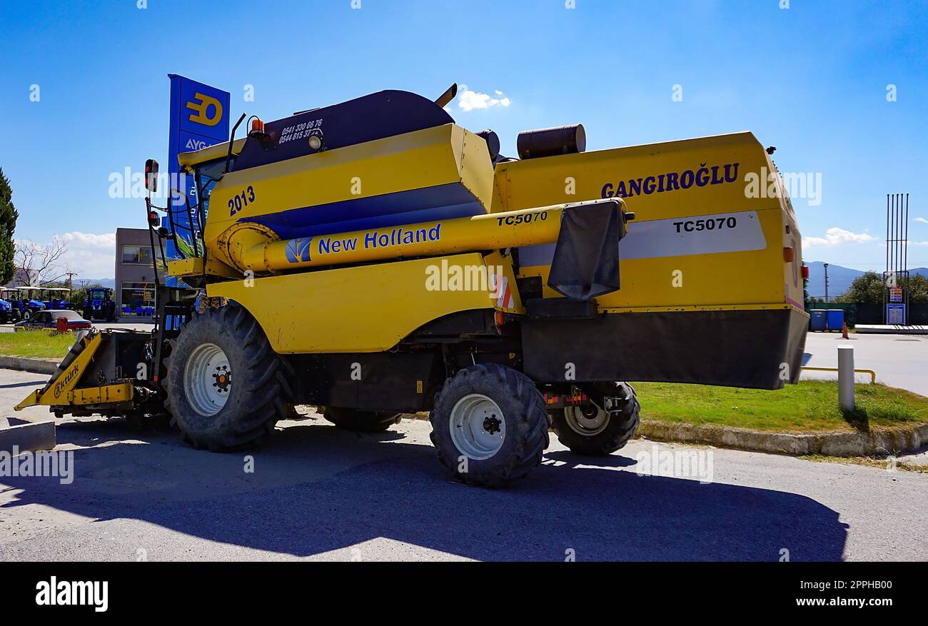 Araclar, Turkey - September 16, 2022: New Holland Agriculture logo in the dealership store against a blue sky at Araclar, Turkey Stock Photo