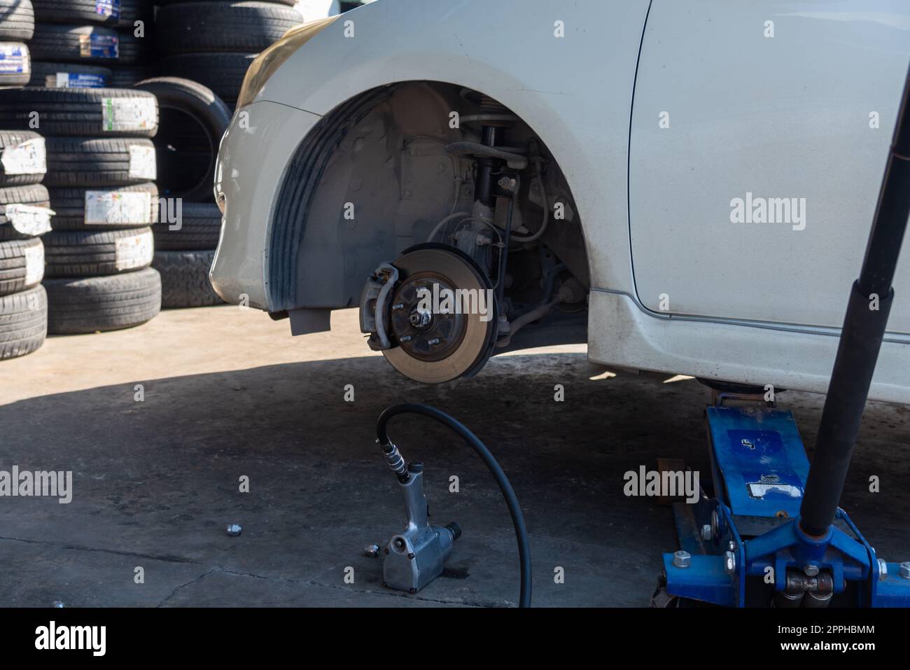 Change a car tire caused by a flat tire by using a jack to lift the car