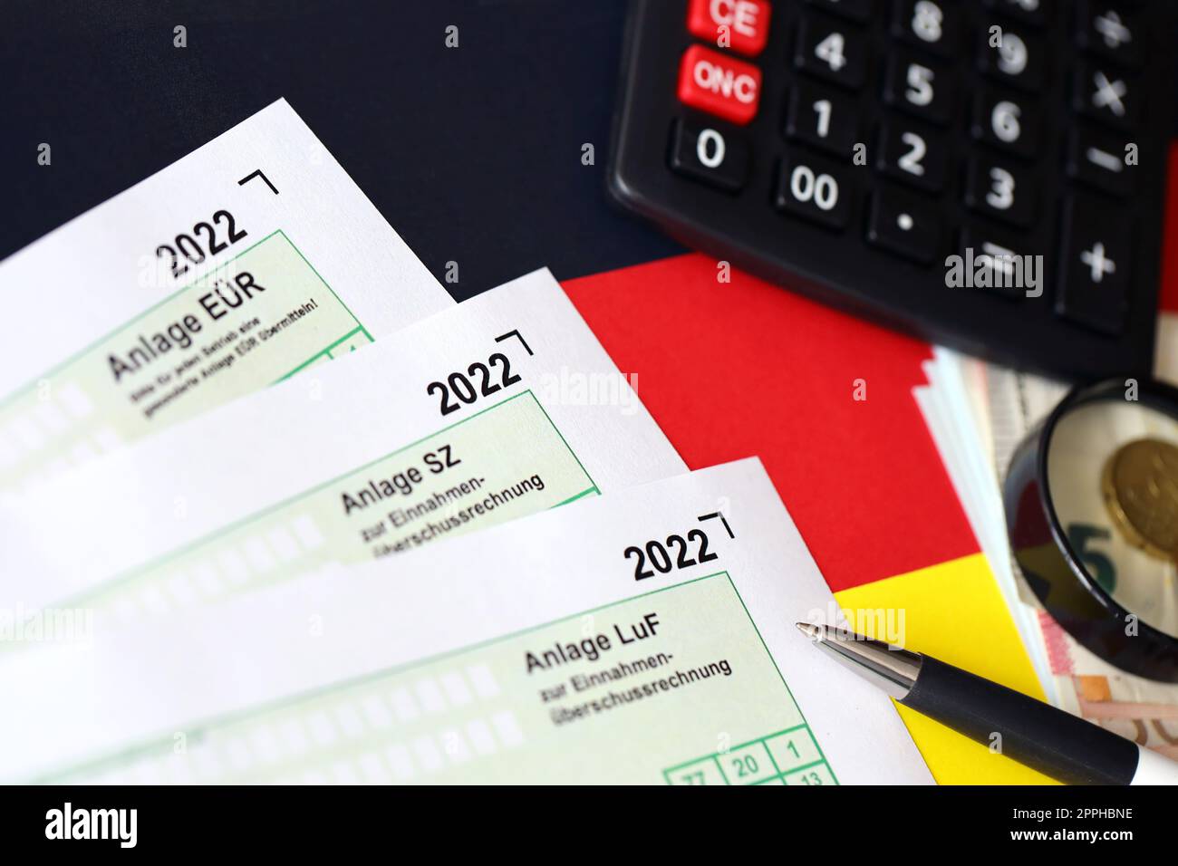 German different tax declaration blank forms - Anlage EUR, Anlage SZ and Anlage Luf. Documents lies with calculator, pen and european money Stock Photo