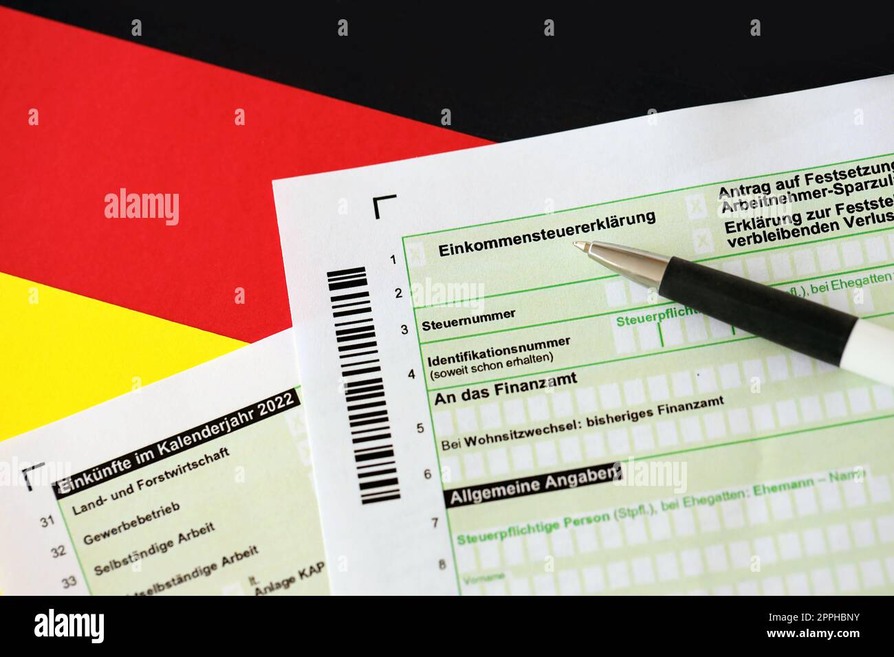 German annual tax return declaration form with pen on flag close