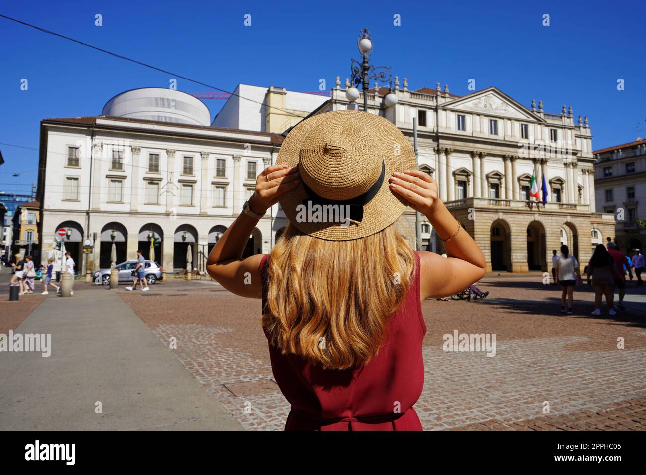 Fashion young woman in Piazza della Scala square in Milan, Italy Stock Photo