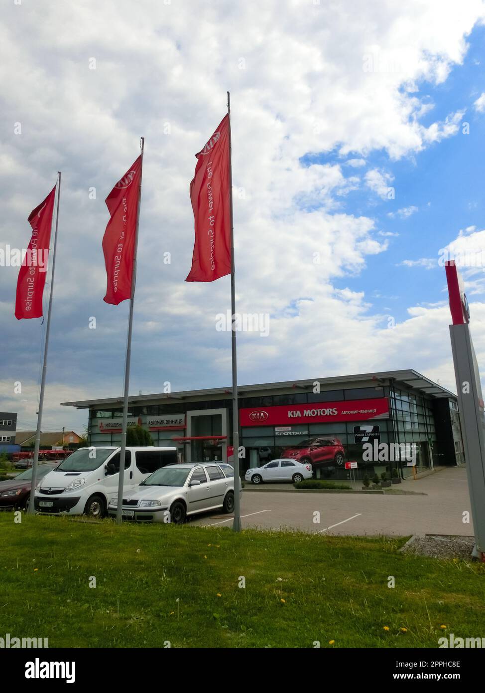 View of the KIA brand dealership store.KIA Motors is a South Korean automotive company producing passenger cars, vans and buses belonging to the Hyundai Motor Group. Stock Photo