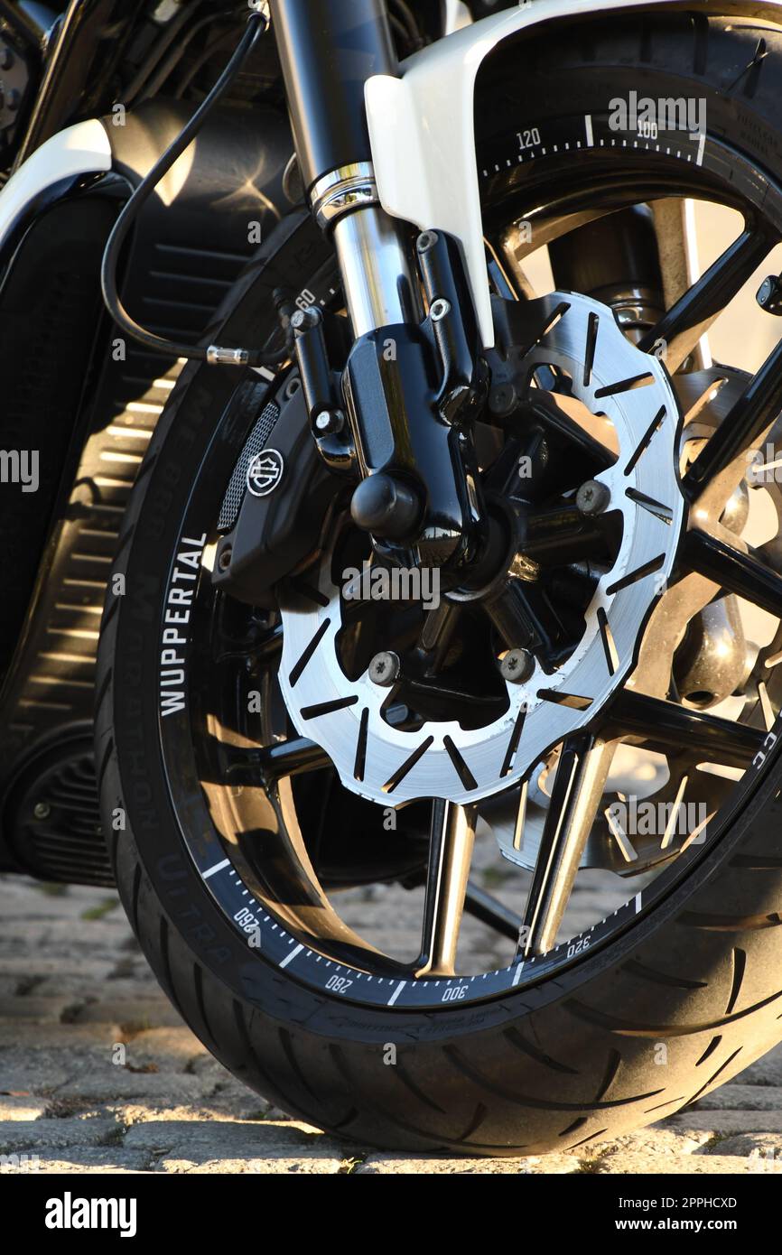 Vertical closeup of a front wheel of a chopper motorcycle Stock Photo