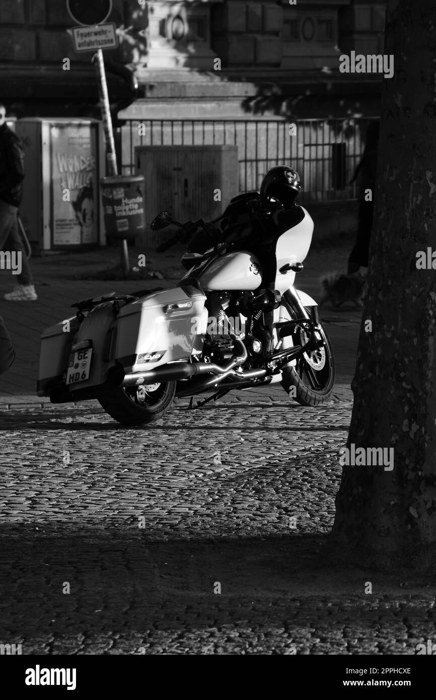Vertical grayscale of a white chopper motorcycle. Harley Davidon in Duesseldorf, Germany. Stock Photo