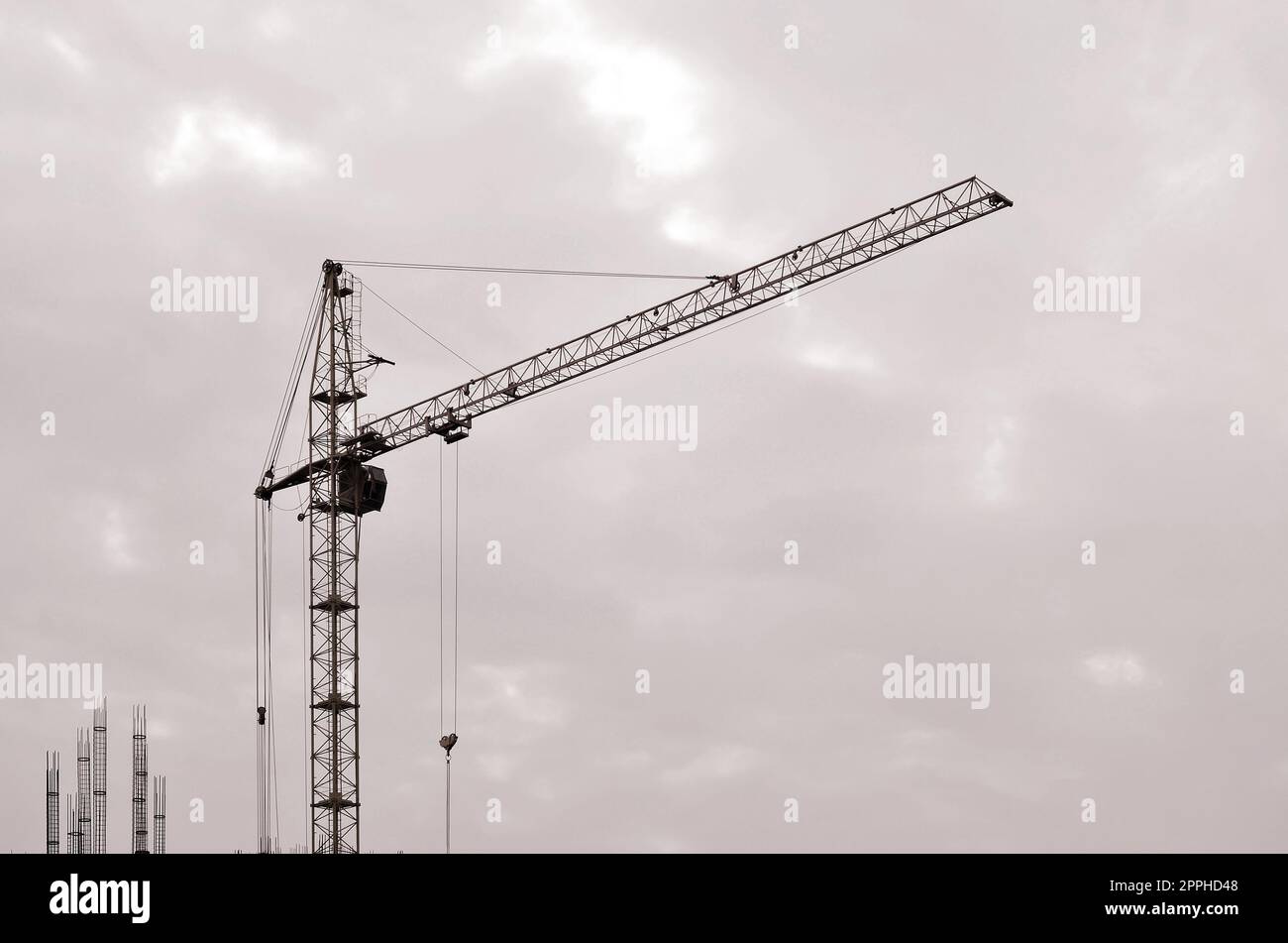 Abstract Industrial background with construction tower cranes over clear blue sky. Construction site. Building under construction concept. Retro tone Stock Photo