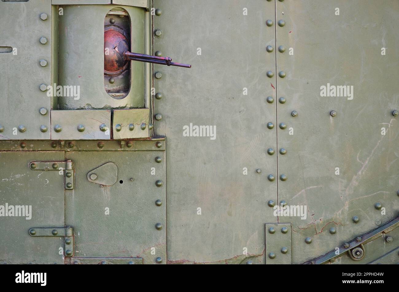 The texture of the wall of the tank, made of metal and reinforced with a multitude of bolts and rivets. Images of the covering of a combat vehicle from the Second World War with a guided machine gun Stock Photo