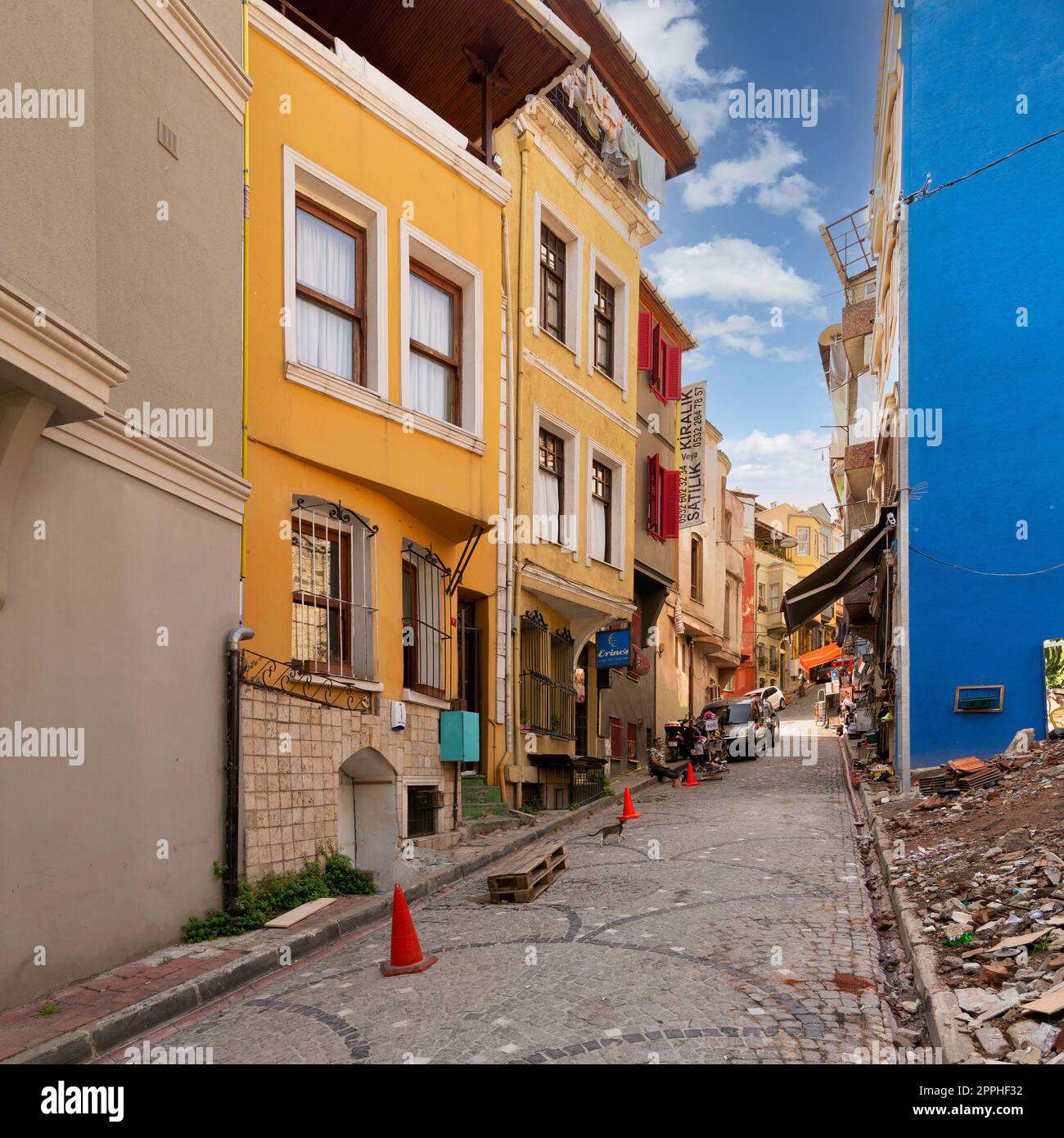 Traditional colorful old houses in Balat district, local pedestrians in a summer, Istanbul, Turkey Stock Photo