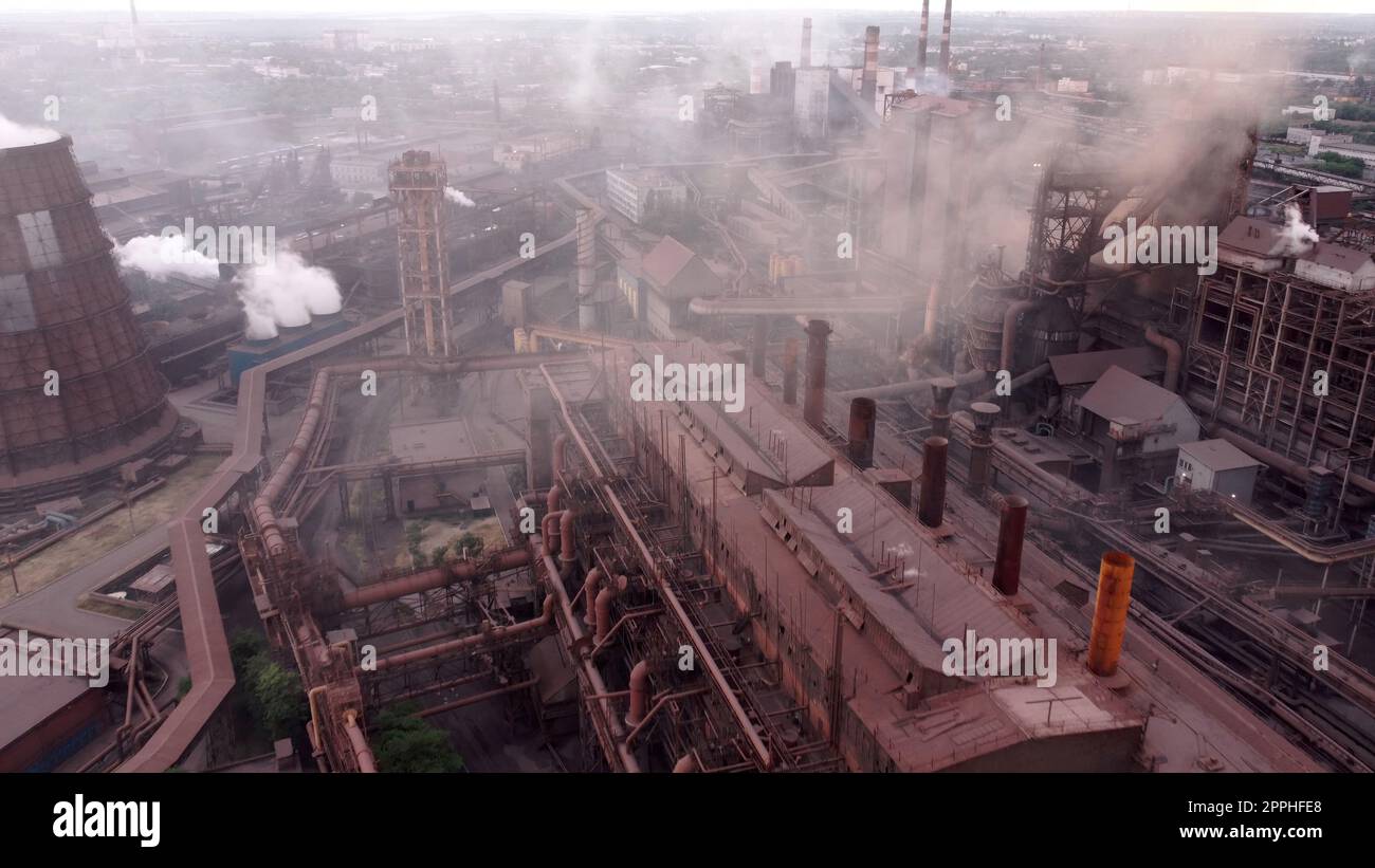 Industrial site or zone with factories, manufacturing plants, power stations, warehouses, cooling towers. Industrial furnace and heat exchanger cracking hydrocarbons in factory. Aerial view. download image Stock Photo