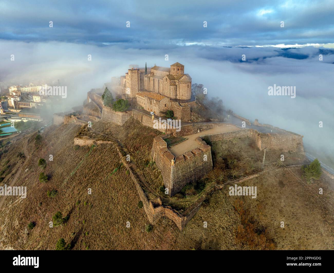 Cardona castle is a famous medieval castle in Catalonia. Between very dense fog that hides the city Stock Photo