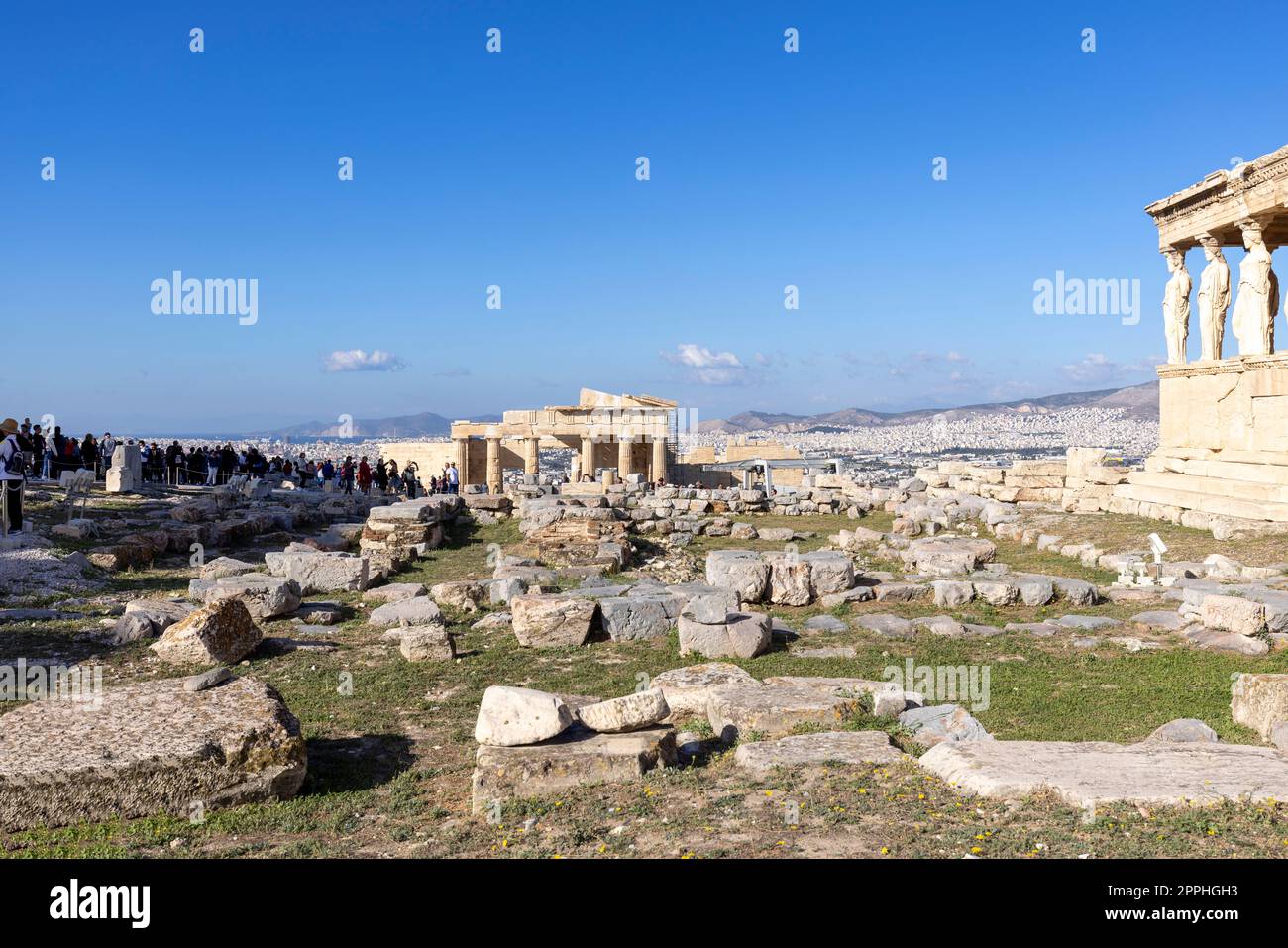 Group of tourists on the ruins of the Acropolis, view of Erechtheion with caryatids and gateway Propylaia, Athens, Greece Stock Photo