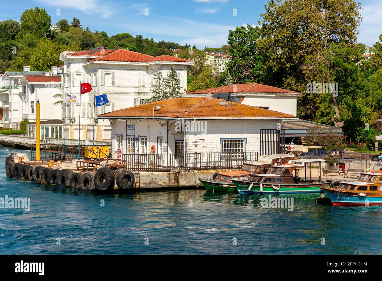 Kanlica Ferry Terminal with background of green trees, and white wooden buildings, Bosphorus, Istanbul, Turkey Stock Photo