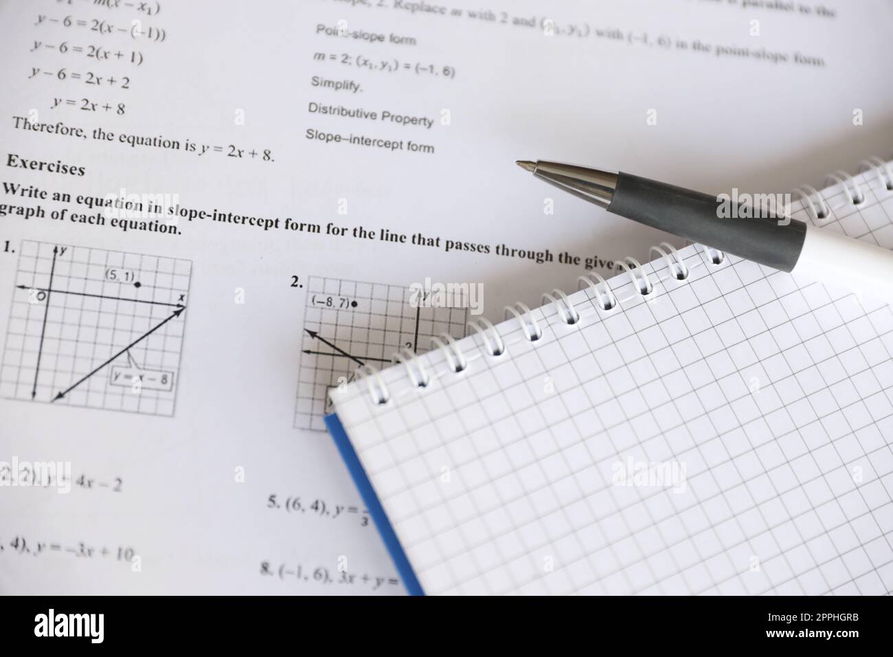 Handwriting of geometrical tasks on examination, practice, quiz or test in geometry class. Solving exponential equations concept. Stock Photo