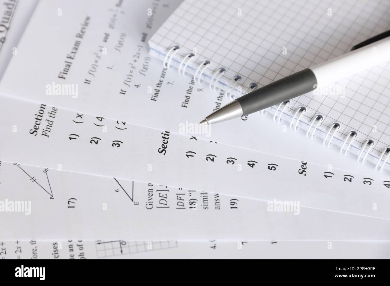 Handwriting of mathematics quadratic equation on examination, practice, quiz or test in maths class. Solving exponential equations concept. Stock Photo