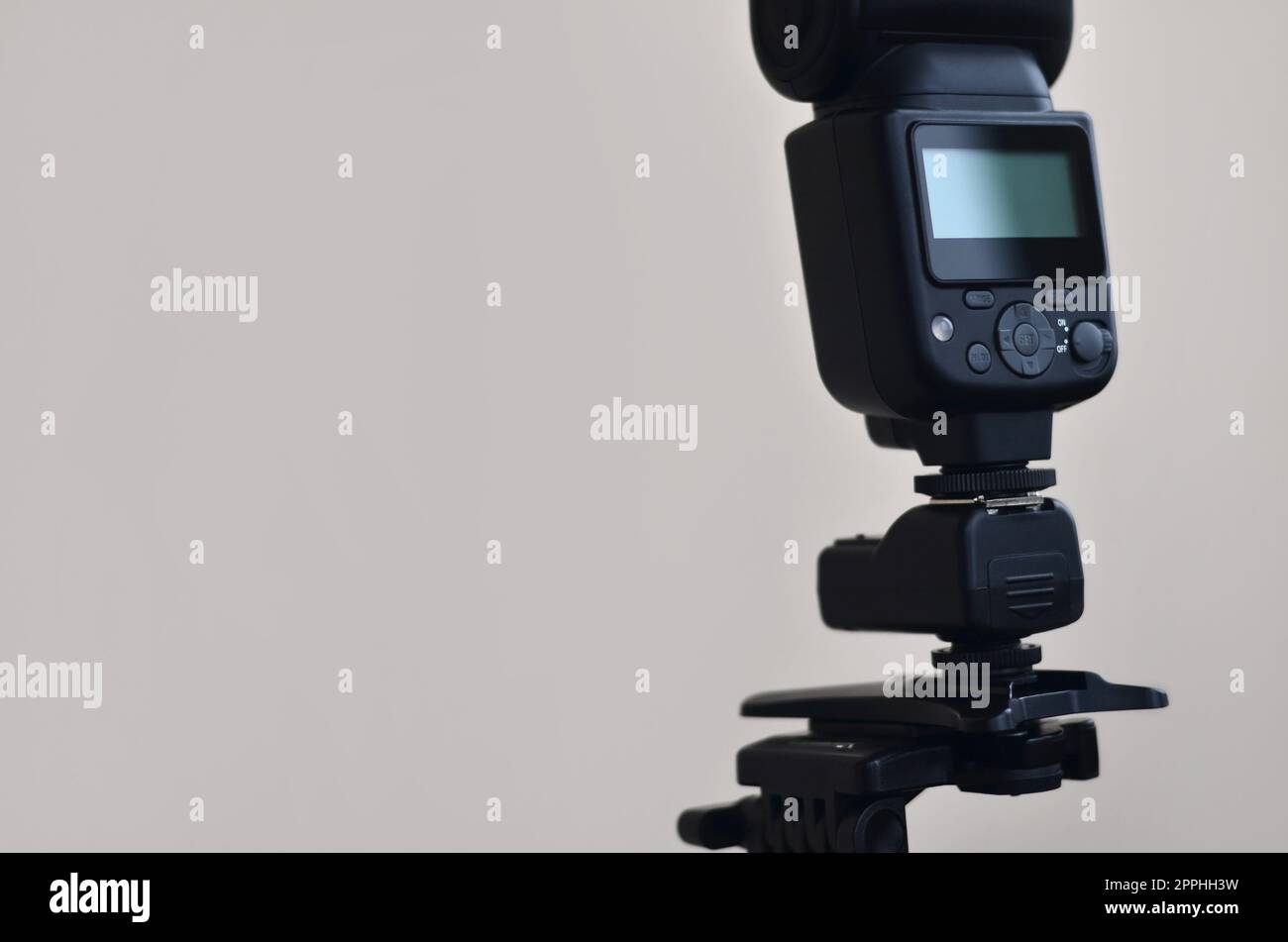 Speedlight gun with trigger set mounted on tripod Stock Photo
