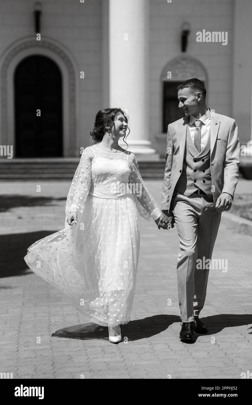 bride in a light wedding dress to the groom in a blue suit Stock Photo ...
