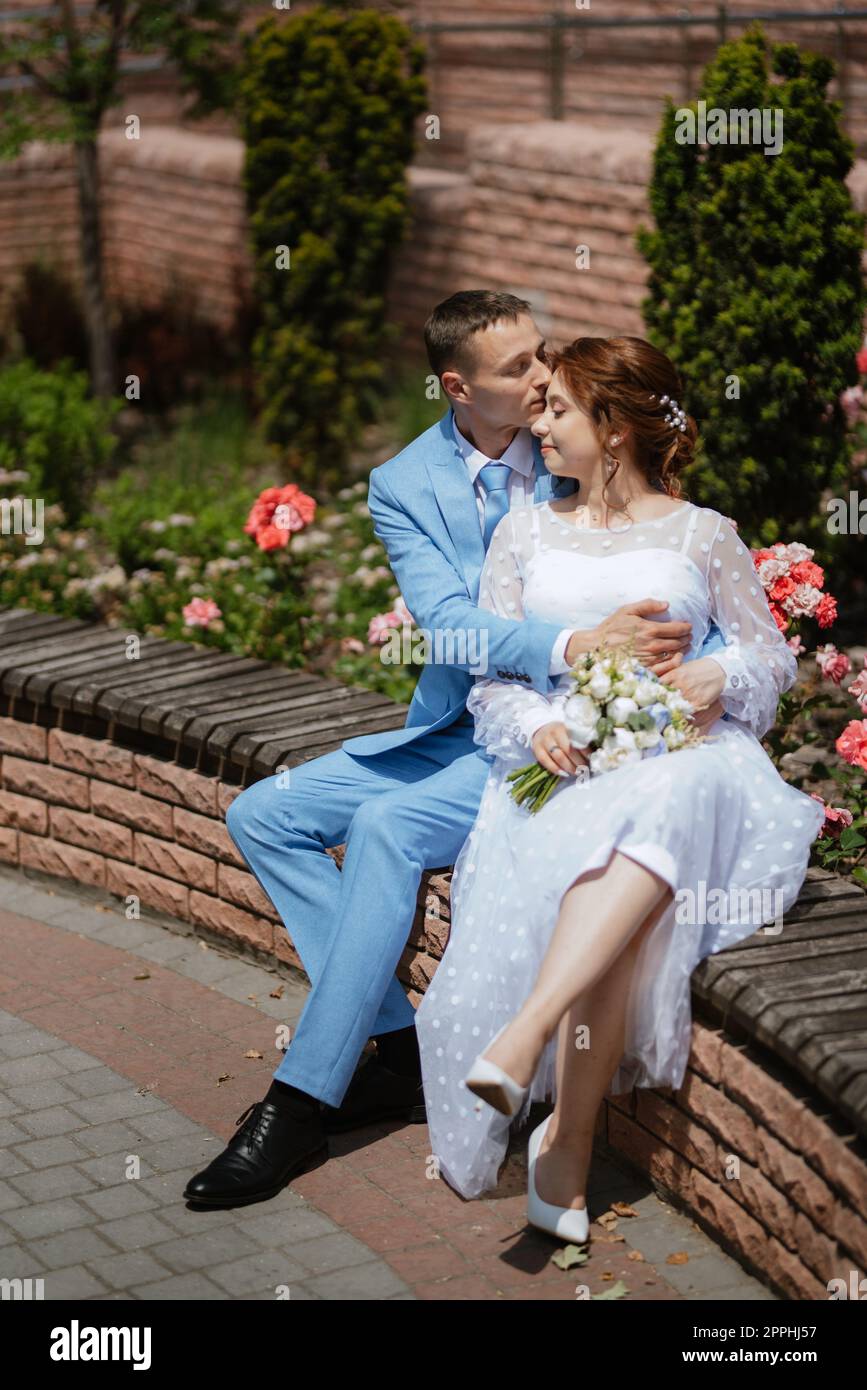 bride in a light wedding dress to the groom in a blue suit Stock Photo