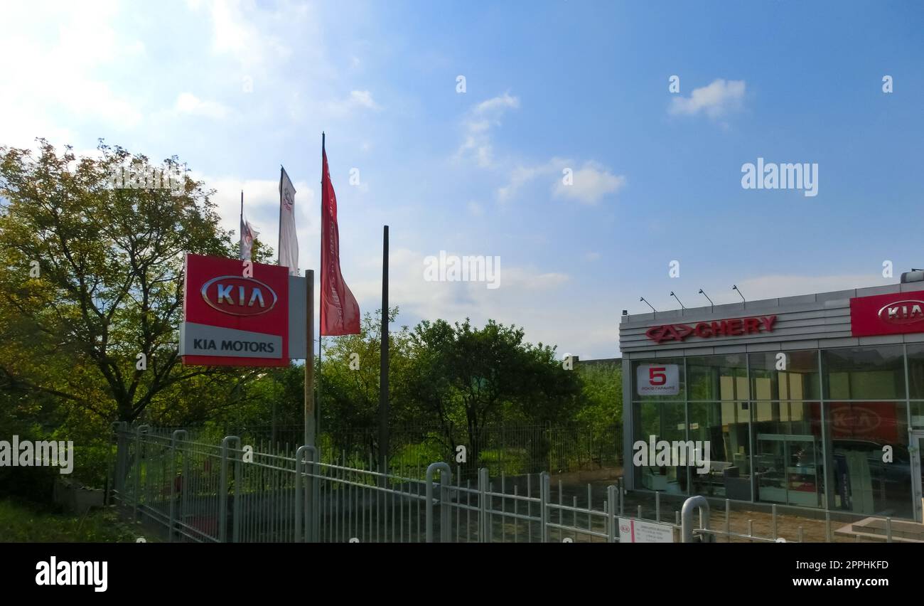 View of the KIA brand dealership store.KIA Motors is a South Korean automotive company producing passenger cars, vans and buses belonging to the Hyundai Motor Group. Stock Photo