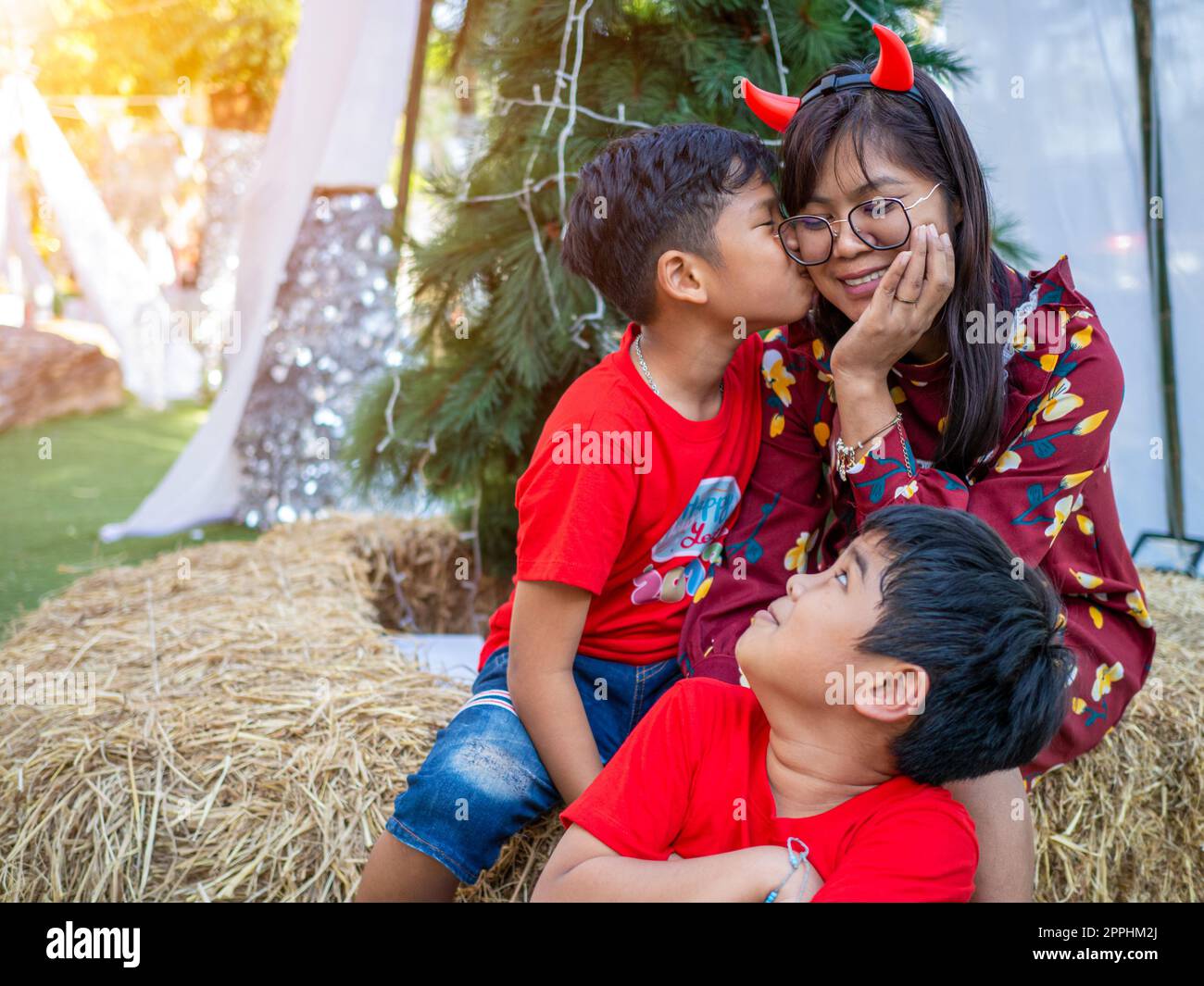 Mother and daughter dressed in red celebrating Christmas. Christmas Festival. Stock Photo