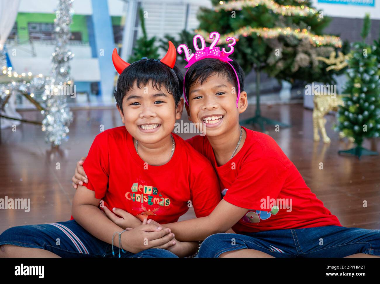 Brothers hugging each other at Christmas To show love within the family. Christmas Festival. Stock Photo