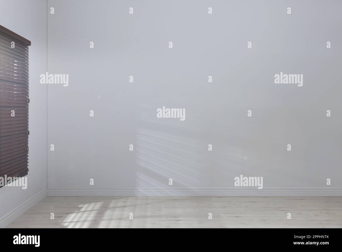 Empty room with white walls, large window and wooden floor Stock Photo