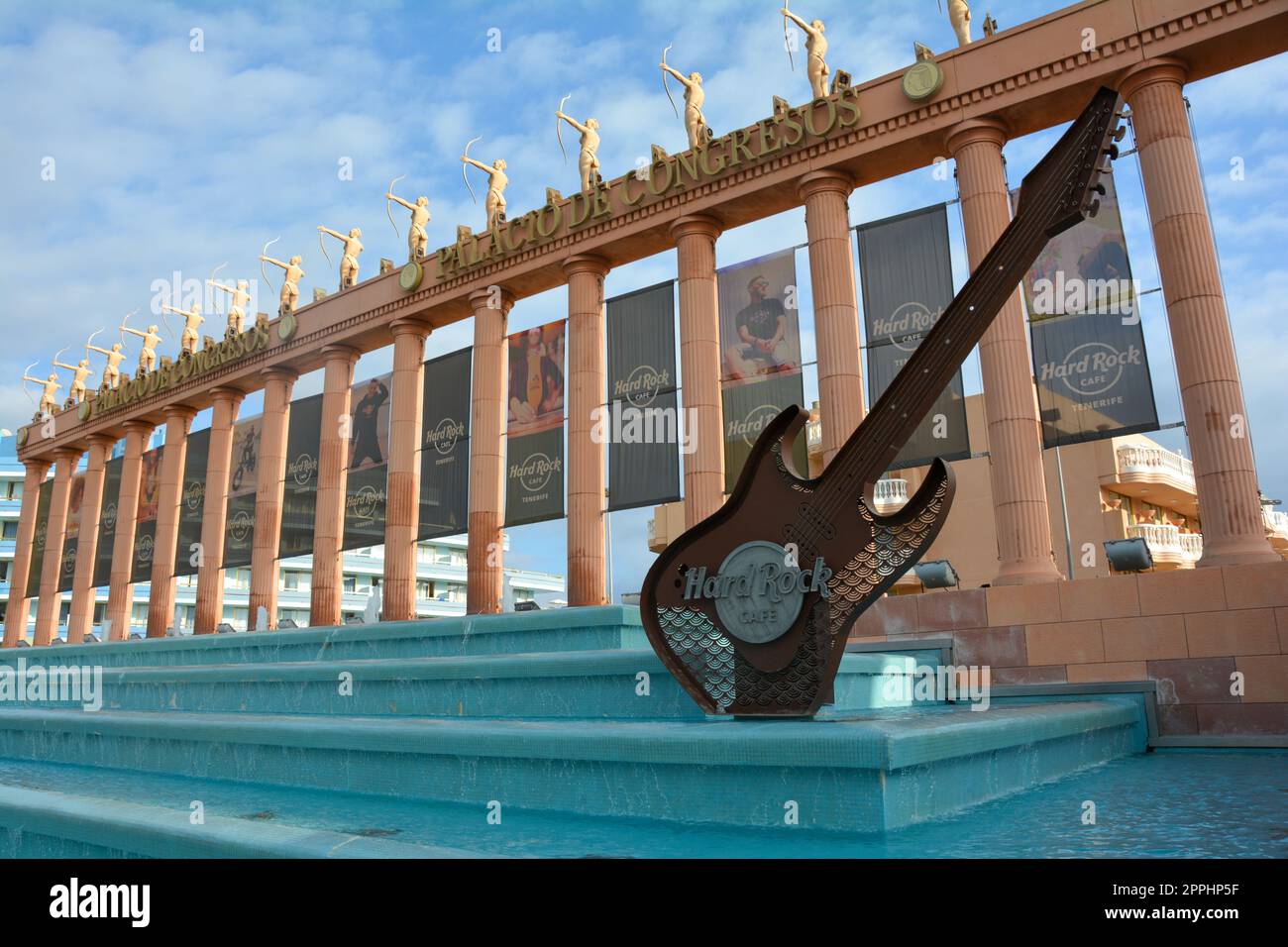 Hard Rock Cafe, Playa de la Americas, Tenerife, Spain August 12, 2022 - Building exterior with guitar , fountain and some archers  figure Stock Photo