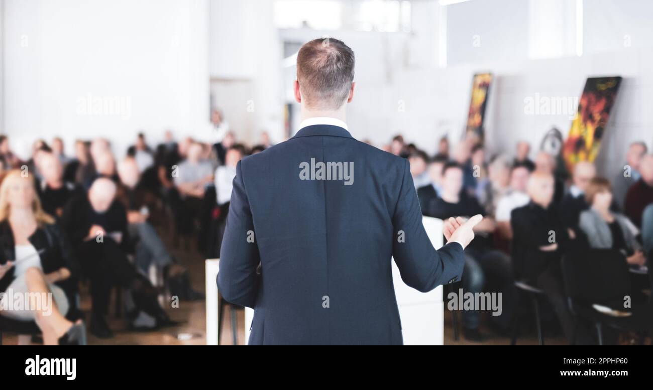 speaker-at-business-conference-with-public-presentations-audience-at