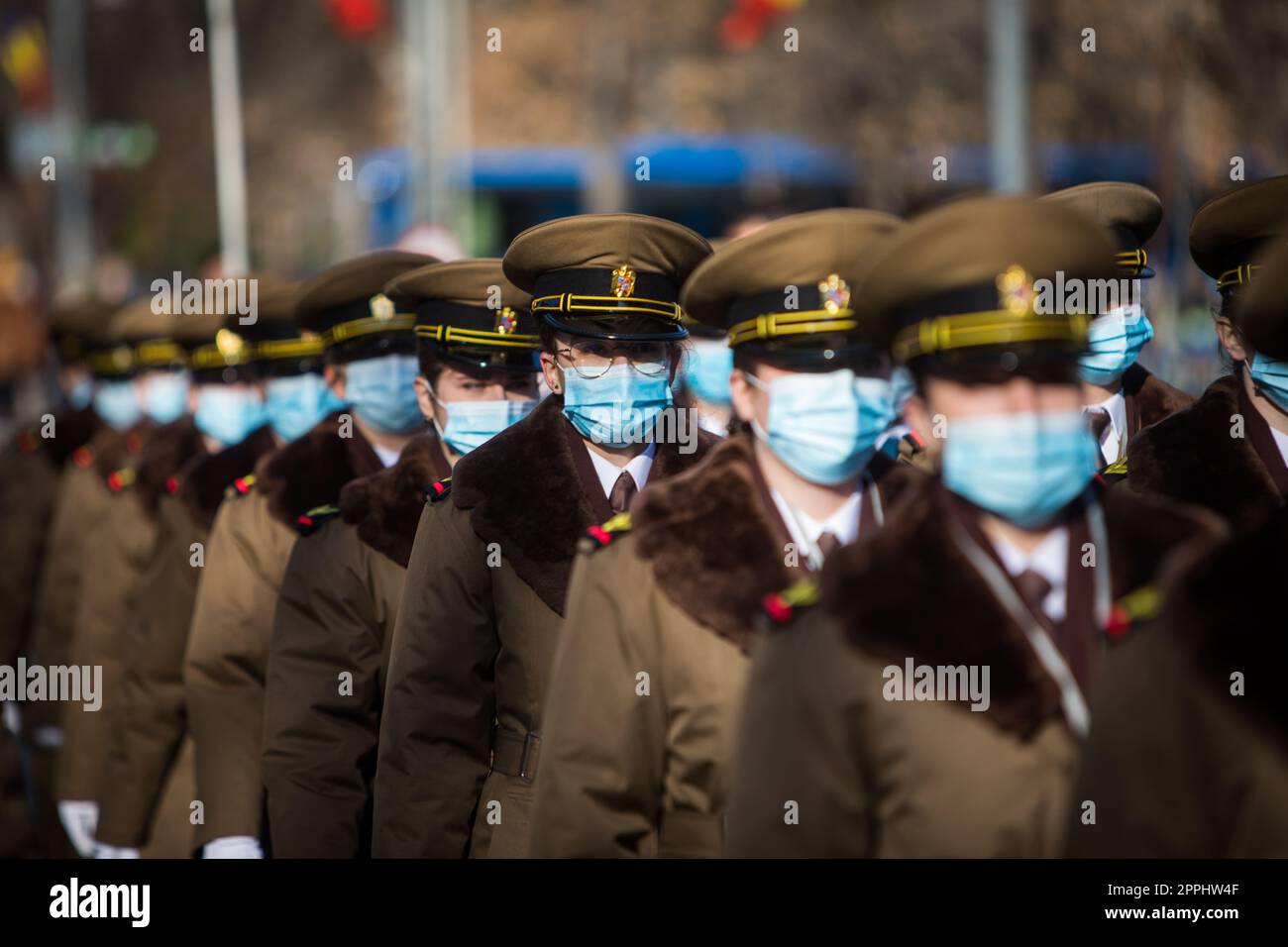 Romanian army soldiers, wearing surgical masks, march Stock Photo