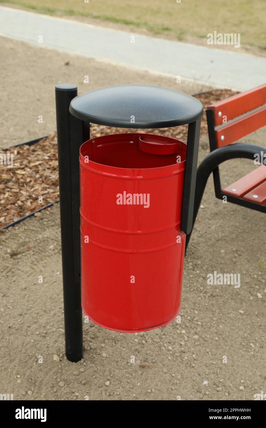 Red metal trash bin on city park Stock Photo Alamy