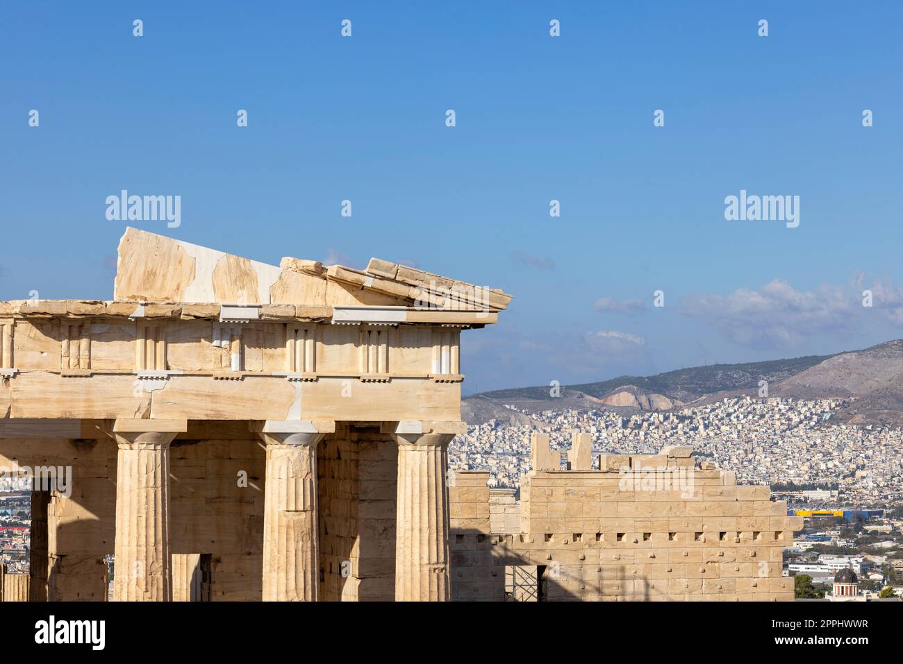 Propylaia, monumental ceremonial gateway to the Acropolis of Athens, Greece. Aerial view of the city in the distance Stock Photo