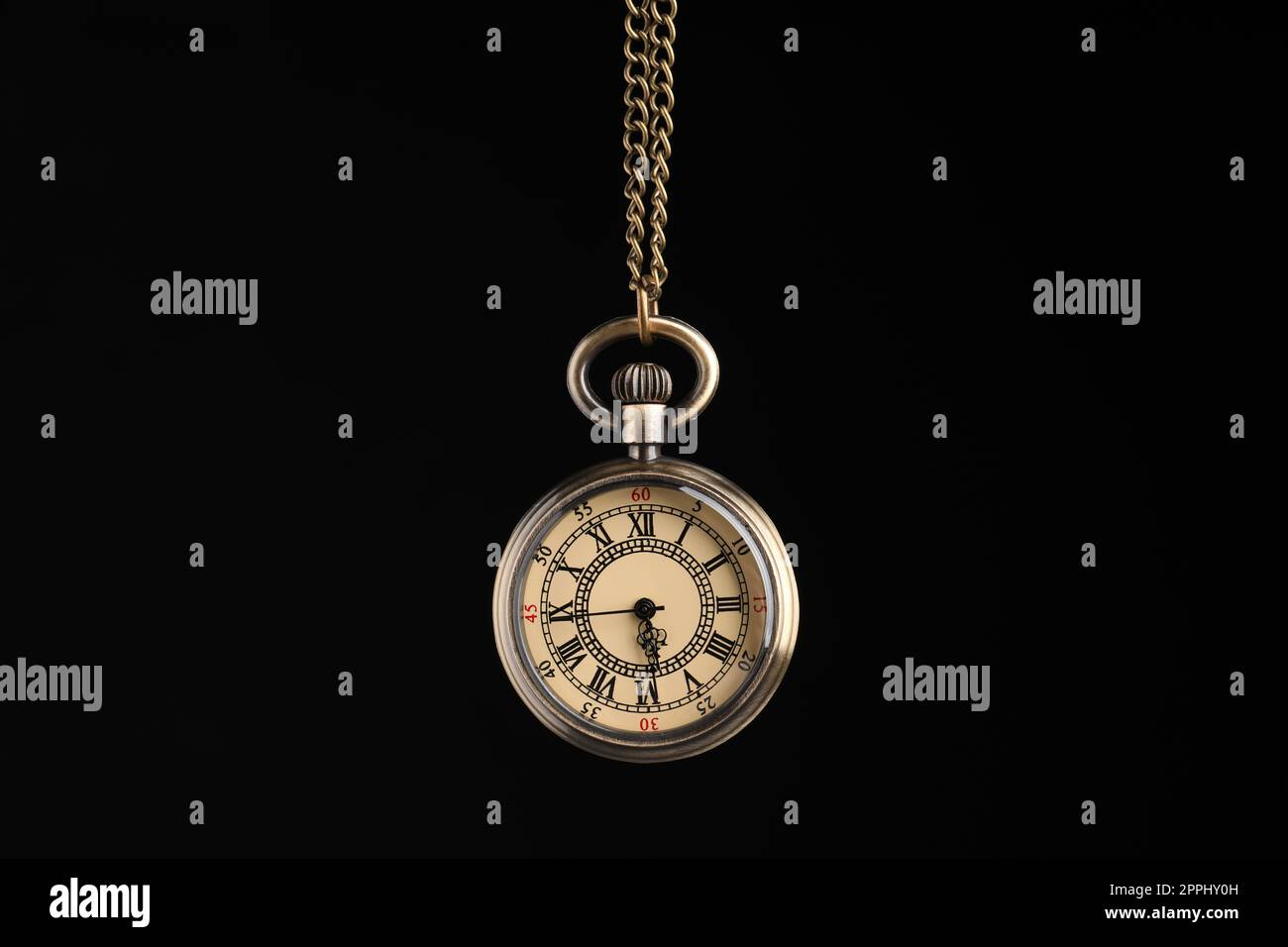 Beautiful vintage pocket watch with chain on black background. Hypnosis